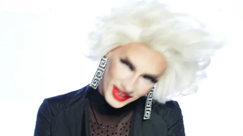 Close-up face of parody actor blonde with red lips, blue eyes and catchy makeup Stock Footage 166002498