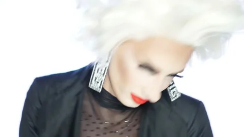 Close-up face of parody actor blonde with red lips, blue eyes and catchy makeup Stock Footage 167613021