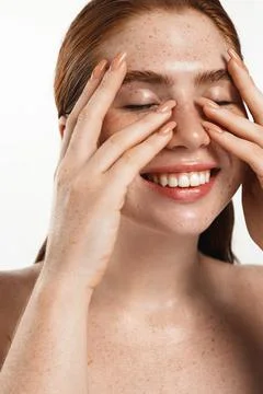Close up face of plus size model with red hair, cleansing washing her face and Stock Photos