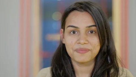 Close-up face portrait of attractive pretty Indian business woman with long blac Stock Footage 102423218