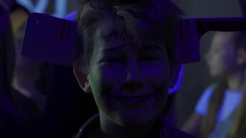 Close up face portrait of kid in dark room at Halloween party. Indoor Blue light Stock Footage 161990748