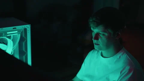 Close-up face of programmer male Illuminated by glow of computer screen and Stock Footage 317165645