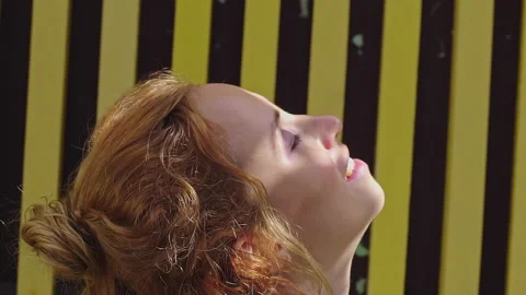 Close up of face red curly haired young woman relaxing in sun light. Stock Footage 160549850