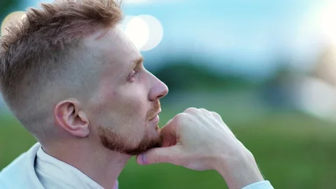 Close-up face of relaxed man thinking touching beard looking at amazing nature Stock Footage 113486603