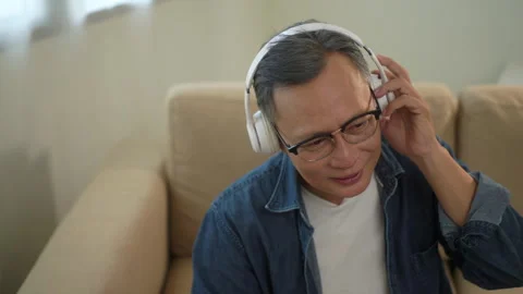 Close up face of senior man enjoy listening to music with headphone, relaxed. Stock Footage 265409280