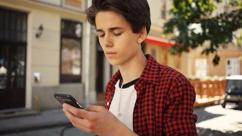 Close up face serious boy using a mobile phone walk keeps skate guy business Stock Footage 92050905