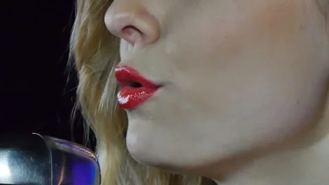 Close-up of the face of the singer with microphone on a black smoky background Stock Footage 105671620