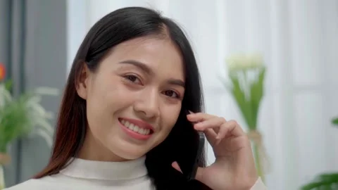 Close up face smiling face asian woman making phone call, working on laptop.. Stock Footage 244974570