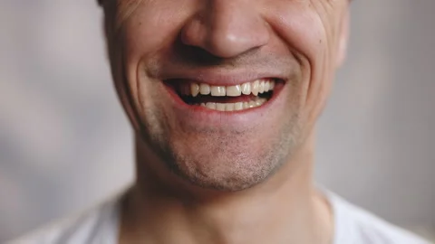 Close up of face smiling teeth isolated. Detail of a smile bearded man Stock Footage 196001708