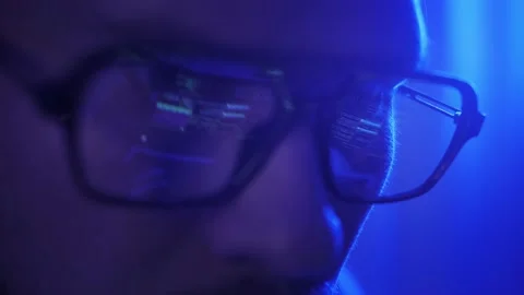 Close-up face of software engineer working on laptop. Line of code in reflection Stock Footage 227493943