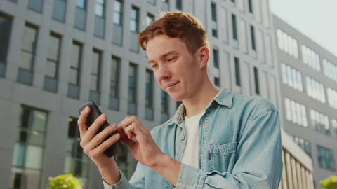 Close up face student young handsome man with red hair sitting on a bench near Stock Footage 142050146