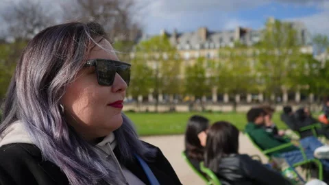 Close-up face of stylish plus size female with dyed purple hair in sunglasses Stock Footage 241420764