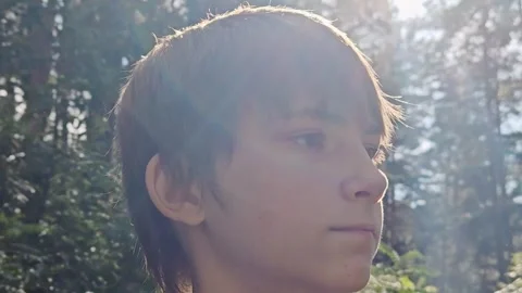 Close-up of a face in sunlight, a young guy. Portrait of Caucasian handsome guy Stock Footage 315499581