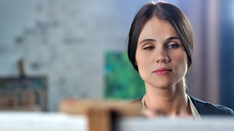 Close-up face of talented concentration female painter enjoying drawing picture Stock Footage 109044523