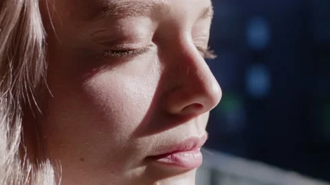Close-up face of tender young beautiful woman with blonde hair closing and Video stock 143593550
