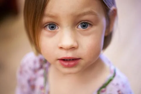 Close up face of three year old girl with big blue eye Stock Photos