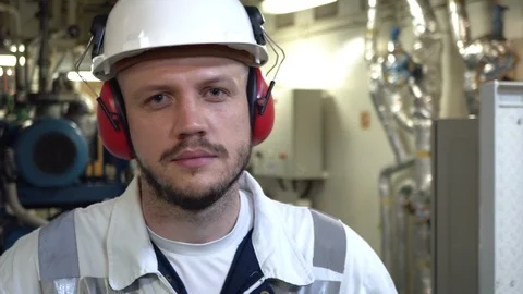 Close-up of the face of a tired engineer in a helmet and headphones. Stock Footage 120524077