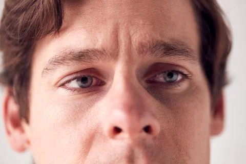 Close Up On Face Of Unhappy Man Shot In Studio Stock Photos