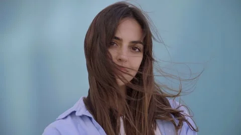 Close up of face. Video on blue background of serious and concentrated young Stock Footage 234749590