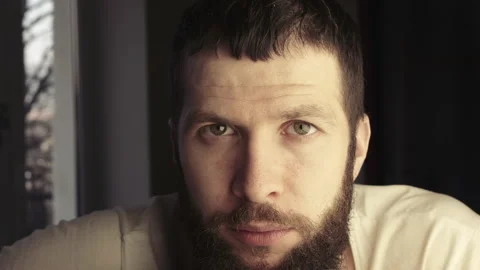 Close-up face without emotion. Handsome bearded caucasian guy looking at the Stock Footage 138999798