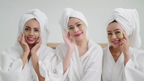 Close up face of woman in bathrobe using eyes patches for fresh under eyes skin Video stock 240699806