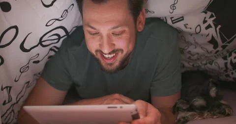 Close up of face of a young bearded and mustashed man, using digital tablet Stock Footage 140147830