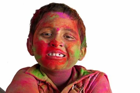 Close up face of young boy playing Holi, smiling with colors Stock Photos
