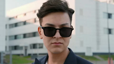 Close up face of young guy in black sunglasses outdoors. Stockbeeldmateriaal 162261516