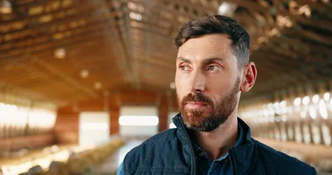 Close up of face of young handsome Caucasian man farmer looking at camera and Видео 138232018