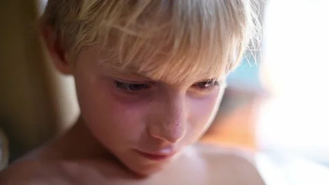 Close up face of young kid with real emotions. Video stock 137673629