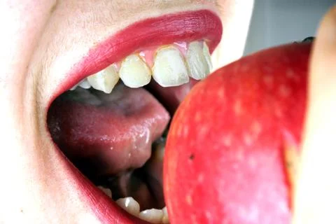 Close up of the face of a young lady with red apple Stock Photos