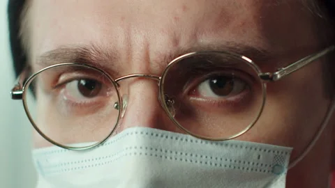 Close-up face of young man in protective mask, wearing glasses, hat. Headshot of Stock Footage 151333839