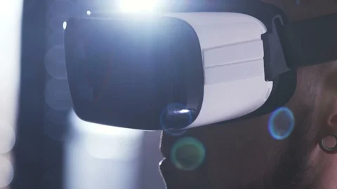 Close-up of face of young man in VR headset. Guy looking around. Virtual reality Stock Footage 98189923