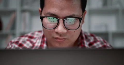 Close up face of young man wearing eyesglasses use laptop computer to shopping Stock Footage 200114101