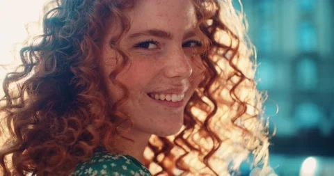 Close up face young sunshine young woman with red hair look at camera smile Video stock 200957051