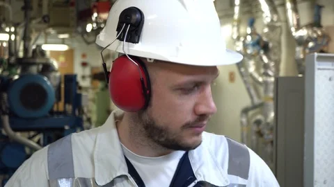 Close-up of the face of a young tired engineer in a helmet and headphones. Stock Footage 120516993