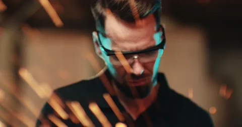 A close-up of the face of a young worker who carefully grinds a metal part with Video stock 167370356