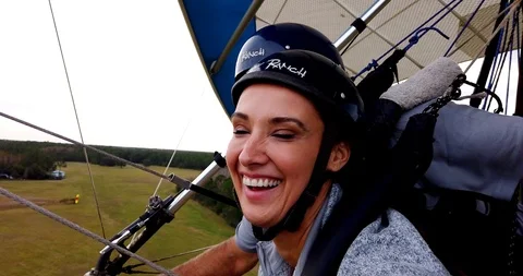 Close Up of Faces as Couple Hang Glides Through Sky,  Gopro Stock Footage 105820790
