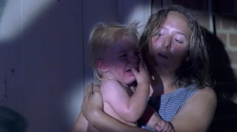 Close-up faces of crying baby and exhausted teenage mother Stock Footage 59545583
