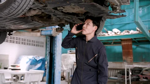 Close-up faces mechanic customer bringing damaged car garage for repairs, Stock Footage 240571397