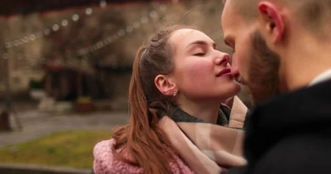 Close-up of the faces of a young couple in love kissing Stock Footage 247186157