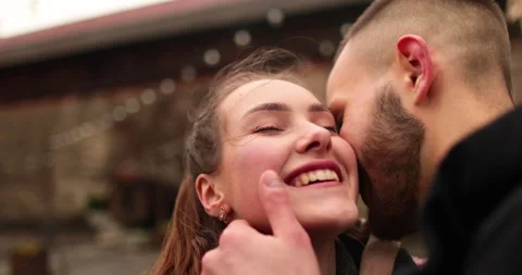 Close-up of the faces of a young couple in love kissing Stock Footage 247186414