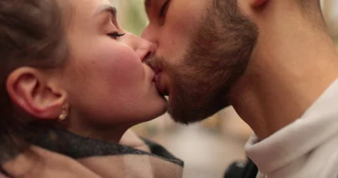 Close-up of the faces of a young couple in love kissing Stock Footage 247187013