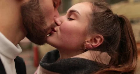 Close-up of the faces of a young couple in love kissing Stock Footage 247187308