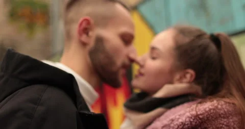Close-up of the faces of a young couple in love kissing Stock Footage 247187719