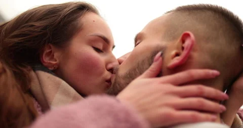 Close-up of the faces of a young couple in love kissing Stock Footage 247188409