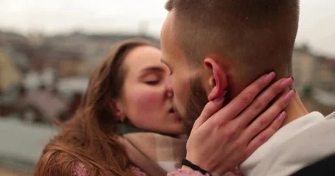 Close-up of the faces of a young couple in love kissing Stock Footage 247188578