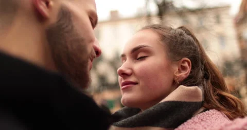Close-up of the faces of a young couple in love kissing Stock Footage 247189179