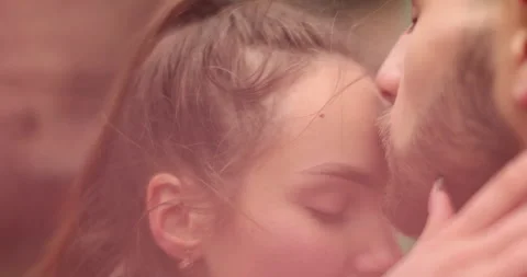 Close-up of the faces of a young couple in love kissing Stock Footage 247190092