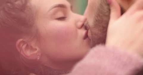 Close-up of the faces of a young couple in love kissing Stock Footage 247190226